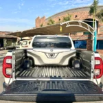 Grey fiberglass luggage box fitted inside Toyota Hilux pickup bed