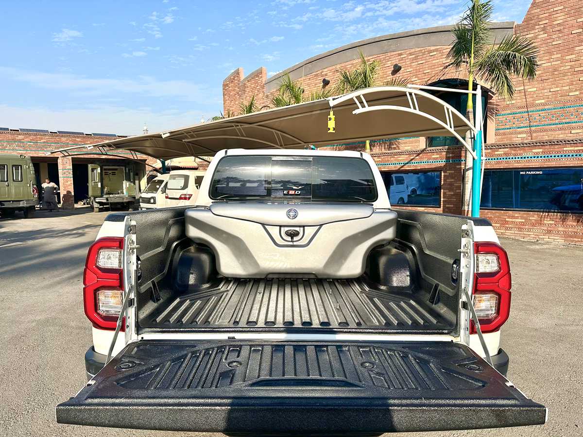 Grey fiberglass luggage box fitted inside Toyota Hilux pickup bed